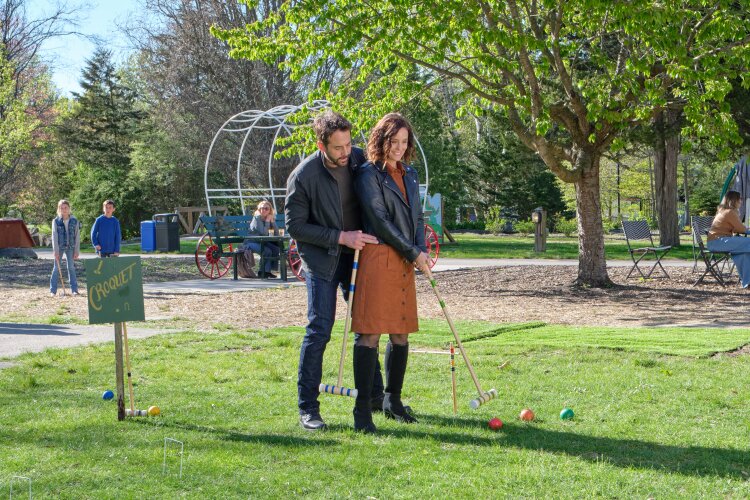 Hallmark Fall Into Love 2026: Full Schedule, Premiere Dates + Filming Locations Niall Matter teaching Ashley Williams golf in Much About Love hallmark fall into love movie